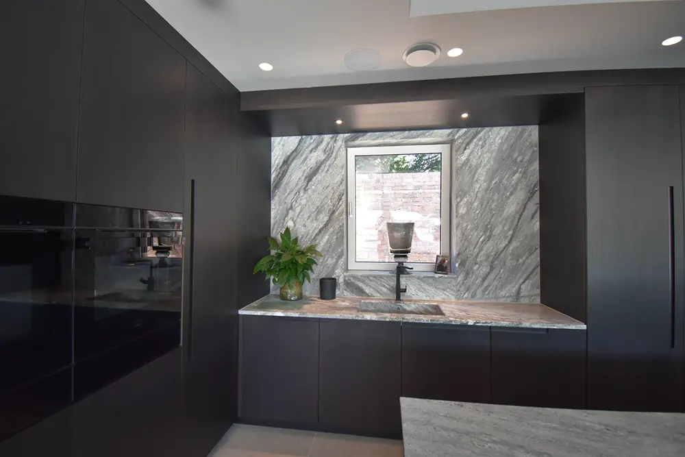 black kitchen with island grey worktop