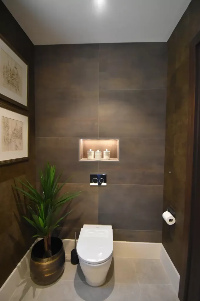 toilet with large brown/black tiles